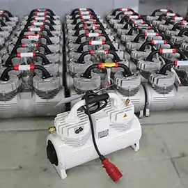 Reihe von grauen Kompressoren mit einem einzelnen weißen Kompressor im Vordergrund.